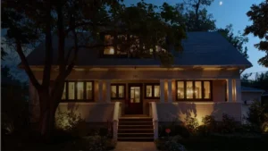 Well-lit home exterior at night with a visible Vivint security sign in the front yard, signaling active smart home alarm system protection and deterrence.